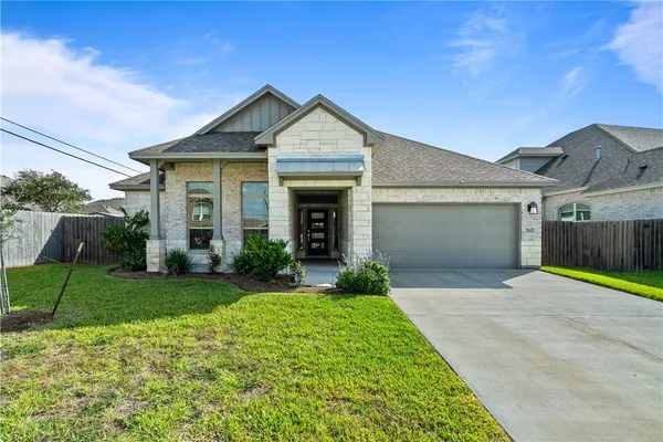 a front view of a house with a yard and garage