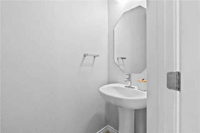 a bathroom with a sink and mirror