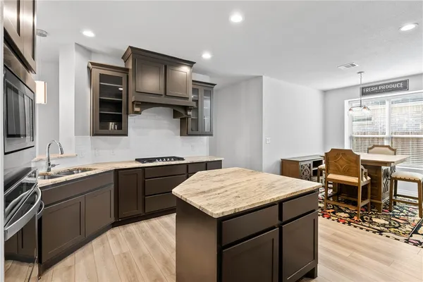 a kitchen with a stove a sink and a refrigerator