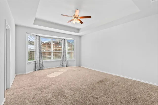 a view of a livingroom with a ceiling fan and window
