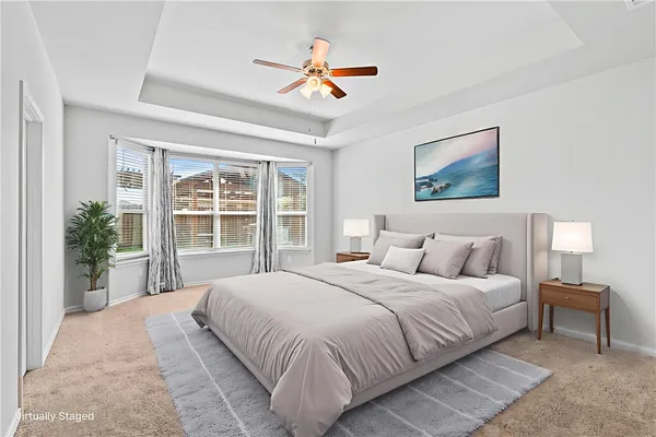 a bedroom with a large bed and a large window