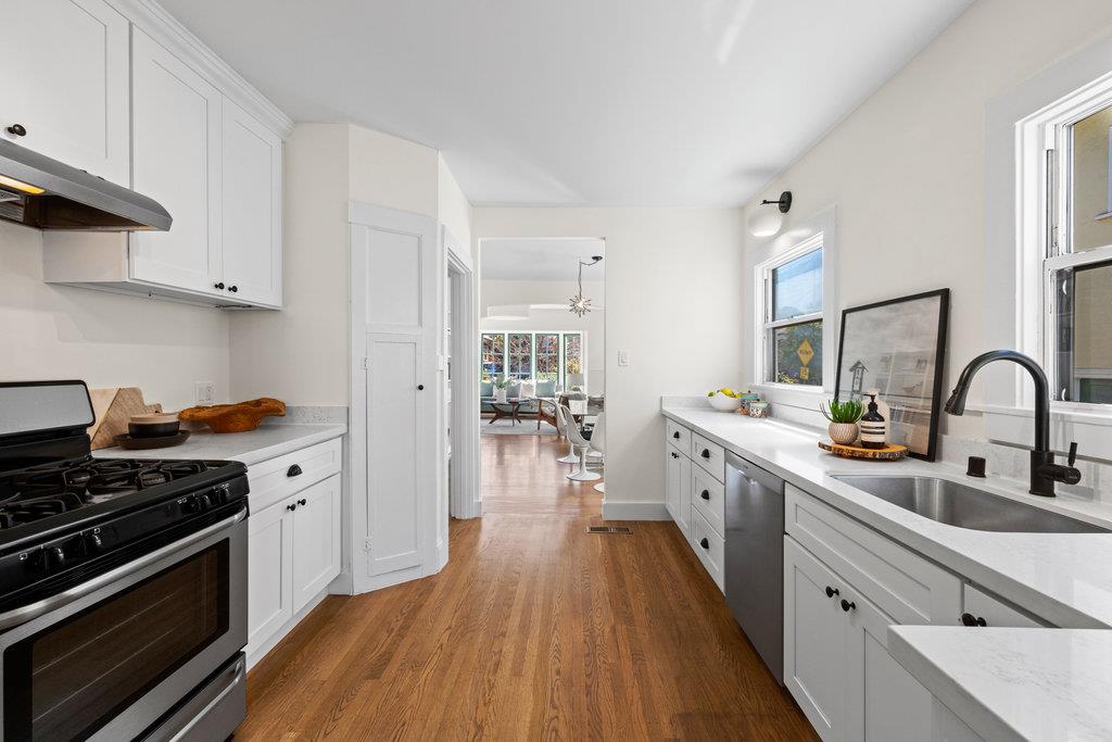 1220 Peralta Avenue Berkeley, CA 94706 - Photo 6 of 15 a kitchen with sink a stove and cabinets