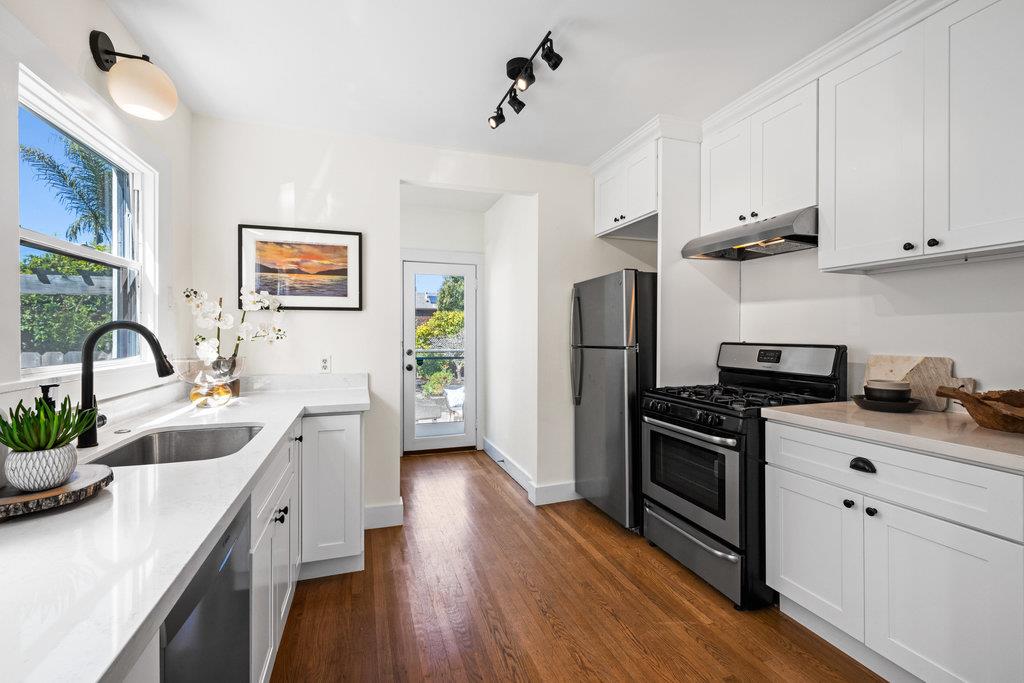 1220 Peralta Avenue Berkeley, CA 94706 - Photo 7 of 15 a kitchen with stainless steel appliances granite countertop a sink stove and refrigerator
