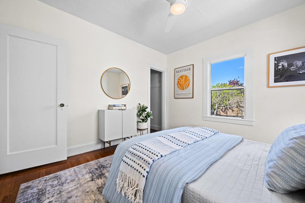 1220 Peralta Avenue Berkeley, CA 94706 - Photo 9 of 15 a bedroom with a bed and a wooden floor