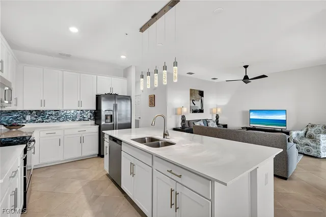 a kitchen with stainless steel appliances a sink stove and refrigerator