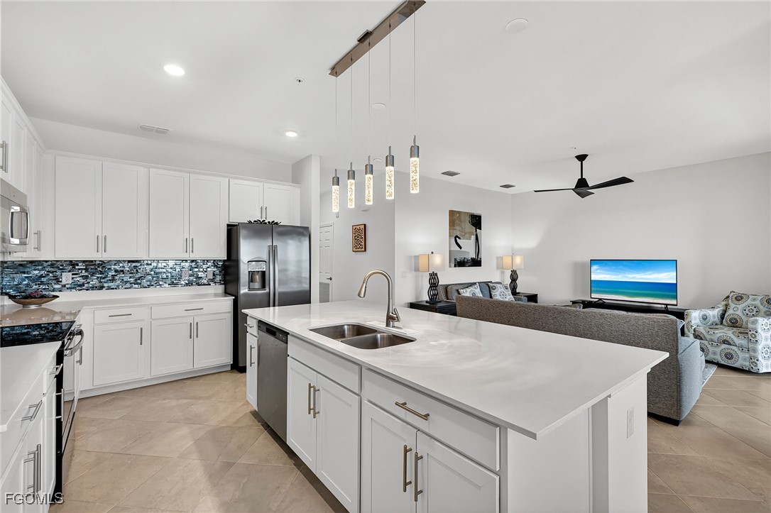 43997 Boardwalk Loop, Unit 1841 Punta Gorda, FL 33982 - Photo 16 of 43 a kitchen with stainless steel appliances a sink stove and refrigerator