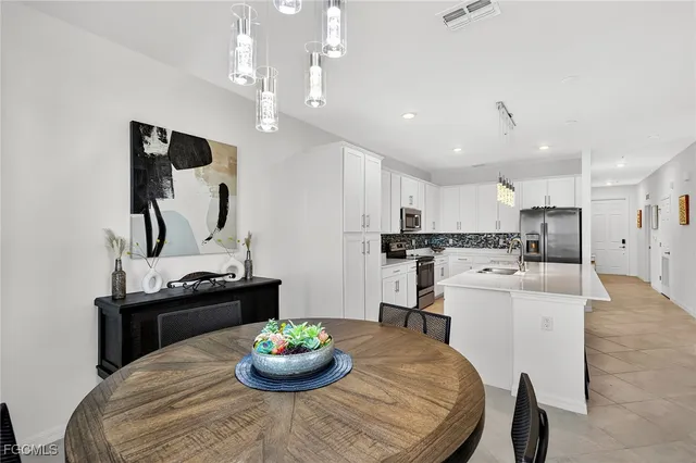 a kitchen with a dining table and chairs