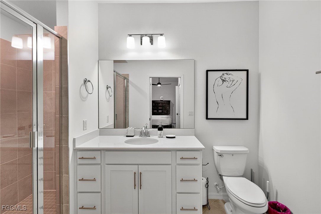 43997 Boardwalk Loop, Unit 1841 Punta Gorda, FL 33982 - Photo 27 of 43 a bathroom with a toilet a sink and mirror