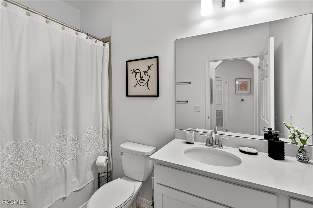 43997 Boardwalk Loop, Unit 1841 Punta Gorda, FL 33982 - Photo 28 of 43 a bathroom with a toilet sink and mirror