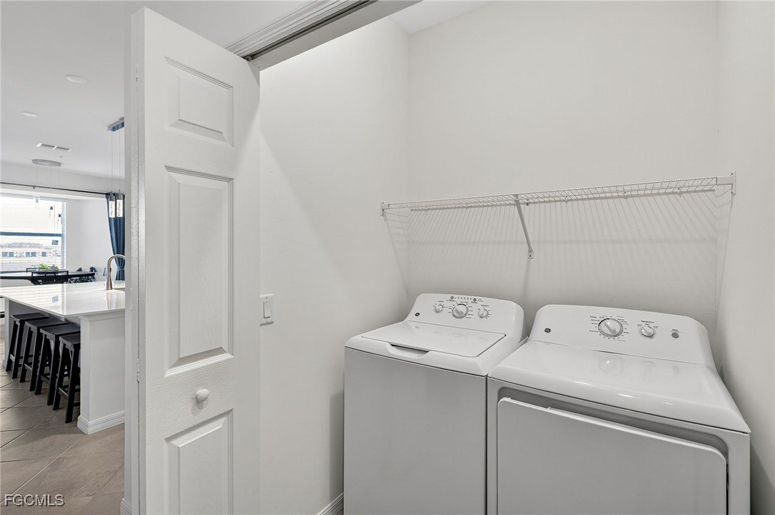 43997 Boardwalk Loop, Unit 1841 Punta Gorda, FL 33982 - Photo 31 of 43 a utility room with dryer and washer