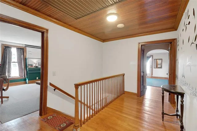 a bedroom with a bed dresser and a flat screen tv