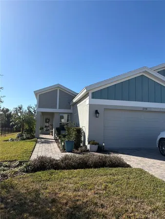 a view of a house with backyard and sitting area