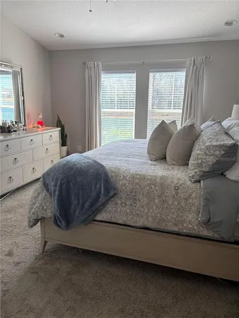 a bedroom with a bed and window