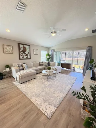 a living room with furniture and a large window