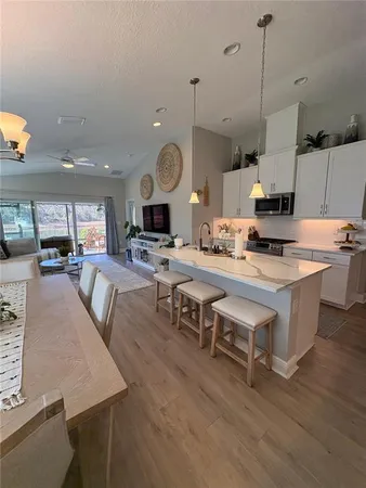 a living room with lots of furniture and kitchen view