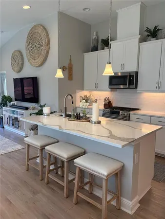 a kitchen with a dining table and chairs