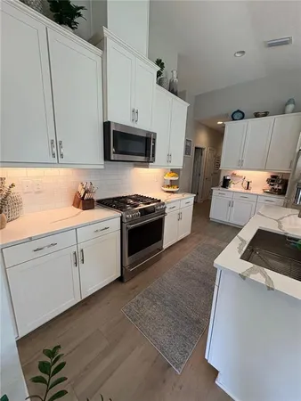 a kitchen with cabinets and white appliances