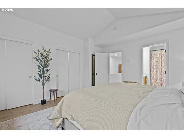 a bedroom with a bed and a potted plant