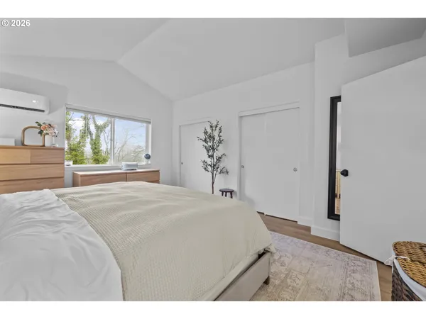 a bedroom with a bed and a large window