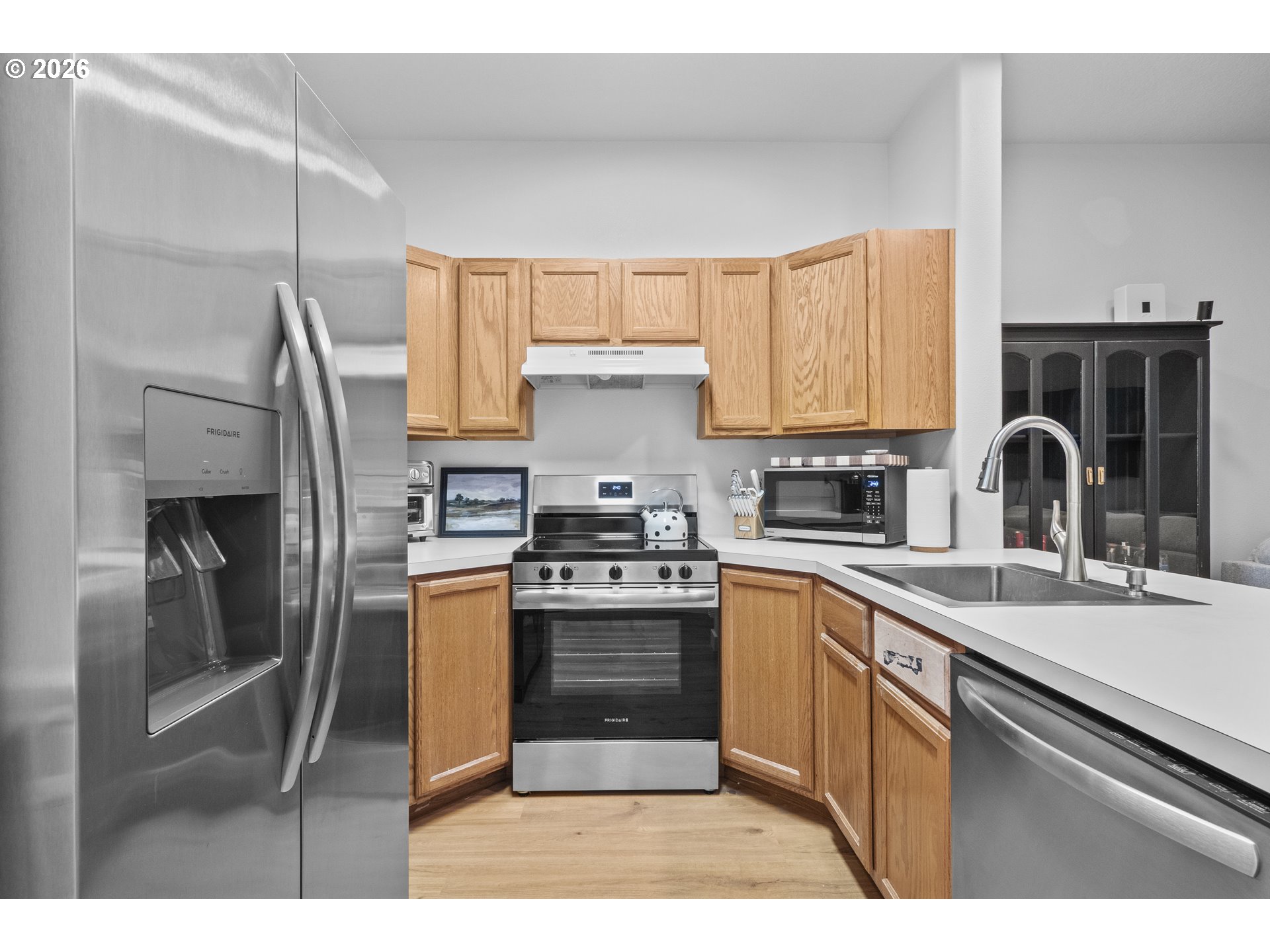 13949 Beavercreek Road, Unit 114 Oregon City, OR 97045 - Photo 4 of 27 a kitchen with stainless steel appliances granite countertop a stove a sink dishwasher a refrigerator and a microwave