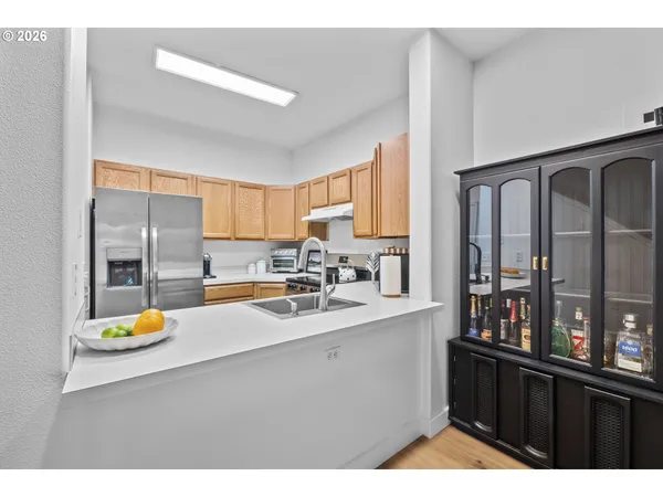 a kitchen with a sink appliances and cabinets