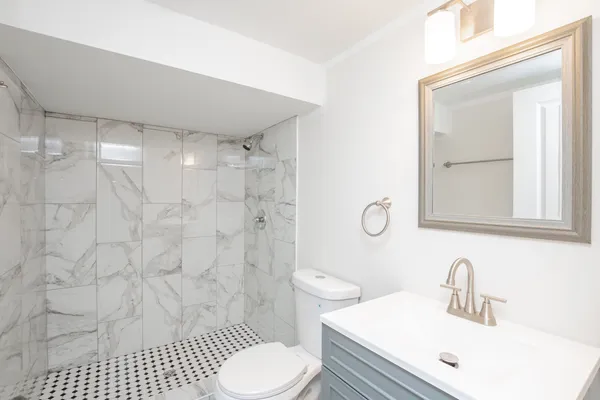 a bathroom with a sink toilet and shower