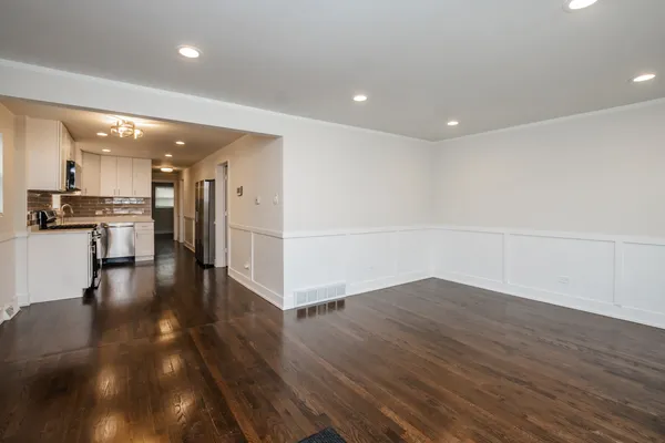 a view of a kitchen with wooden floor and a kitchen