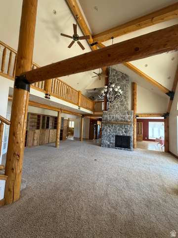 4458 East Glencoe Road Preston, ID 83263 - Photo 5 of 46 Vaulted ceiling with exposed wood beams, stone fireplace, built-in wooden cabinetry, and an upper-level balcony