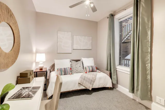 a bedroom with a bed and a mirror