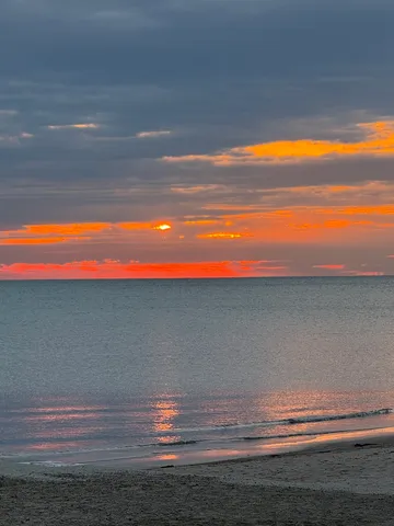 a room with a lamp and wooden floor