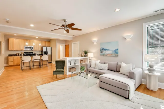 a living room with furniture and kitchen view
