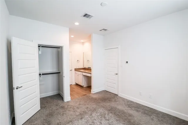 a view of a kitchen with a refrigerator and a sink