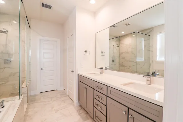 a bathroom with a sink double vanity and a mirror