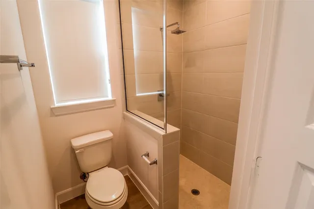 a white toilet sitting next to a bathroom sink