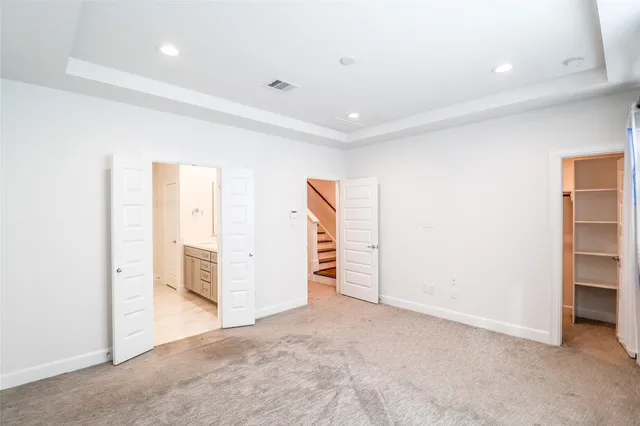 an empty room with closet and natural light