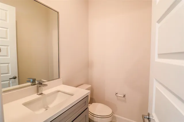 a bathroom with a sink a toilet and mirror