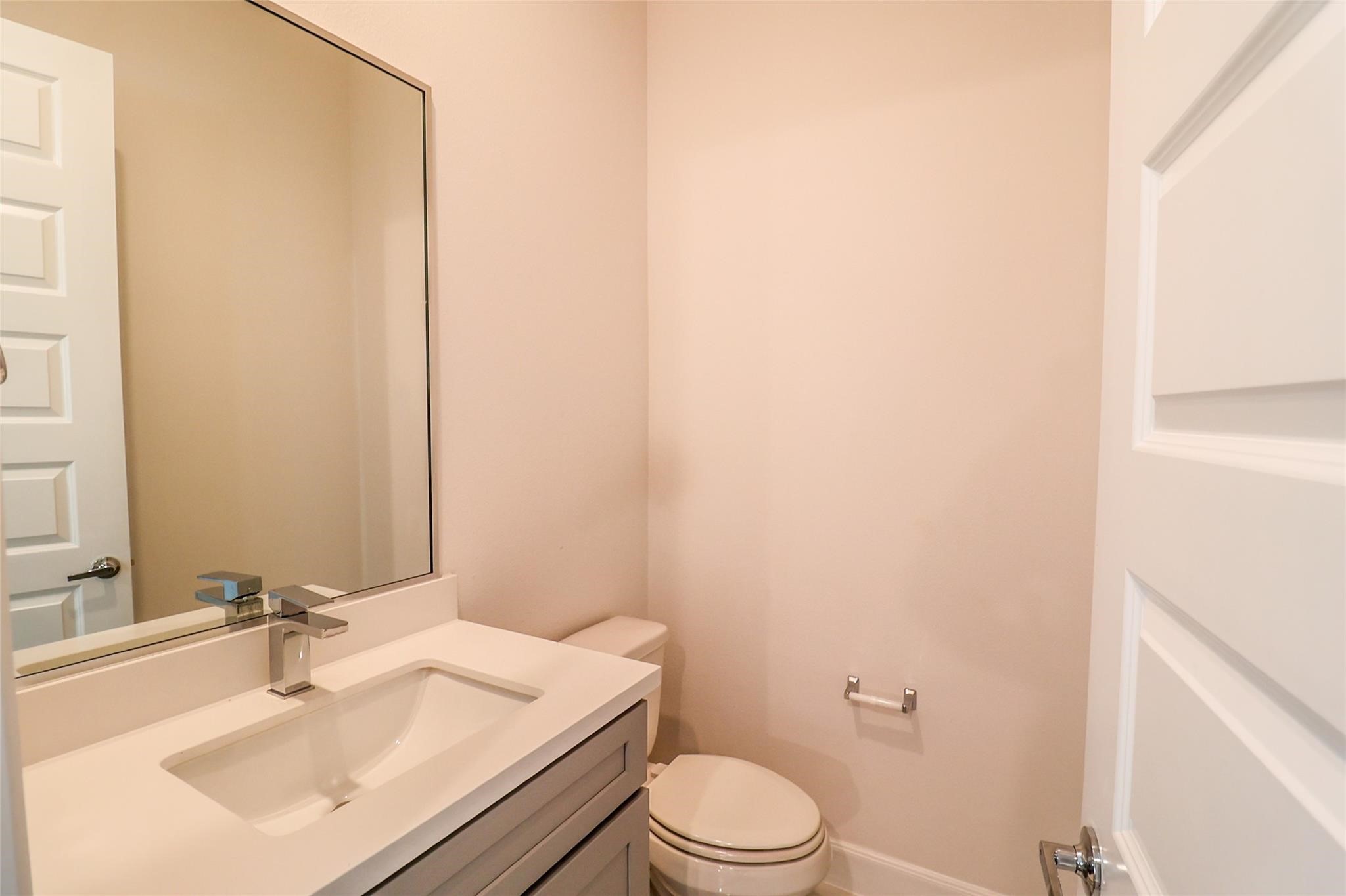2745 Clinton Drive Houston, TX 77020 - Photo 29 of 32 a bathroom with a sink a toilet and mirror