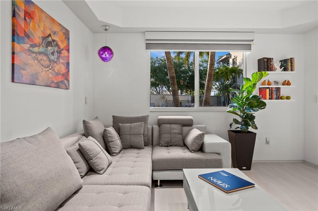 1100 Pine Ridge Road, Unit B103 Naples, FL 34108 - Photo 18 of 38 a living room with furniture and a potted plant