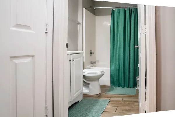 a bathroom with a toilet a sink and shower