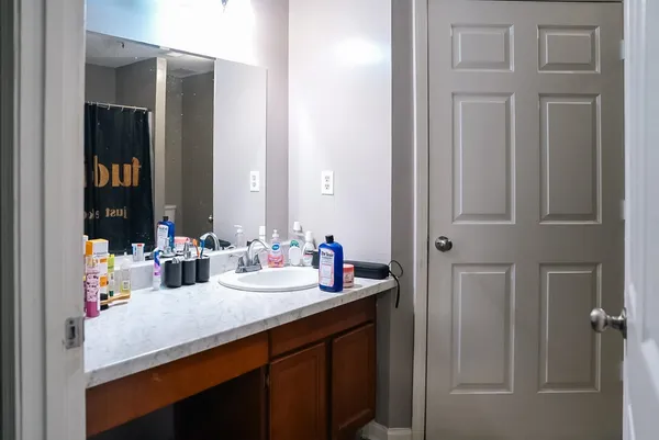 a bathroom with a double vanity sink and a mirror