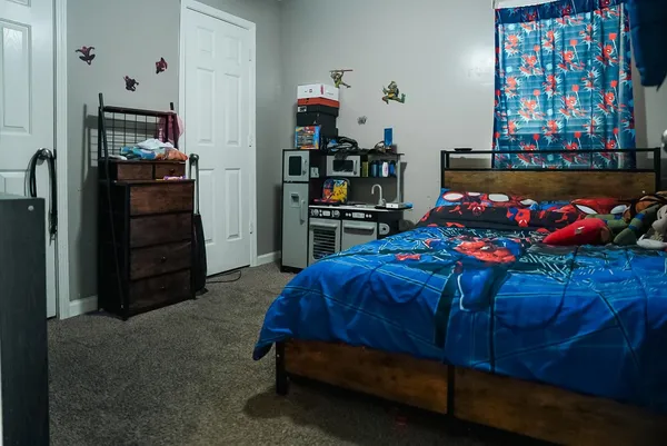 a bedroom with a bed and furniture