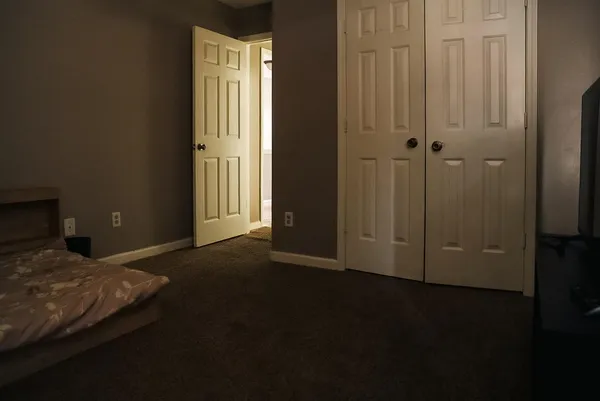 a bedroom with a bed and a cabinets