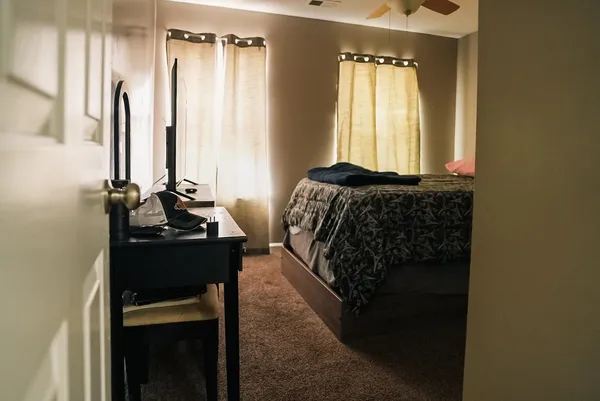 a bedroom with a bed and a dresser