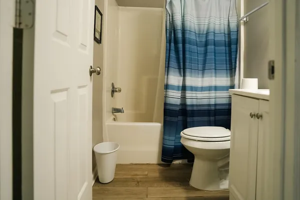 a bathroom with a toilet and a shower