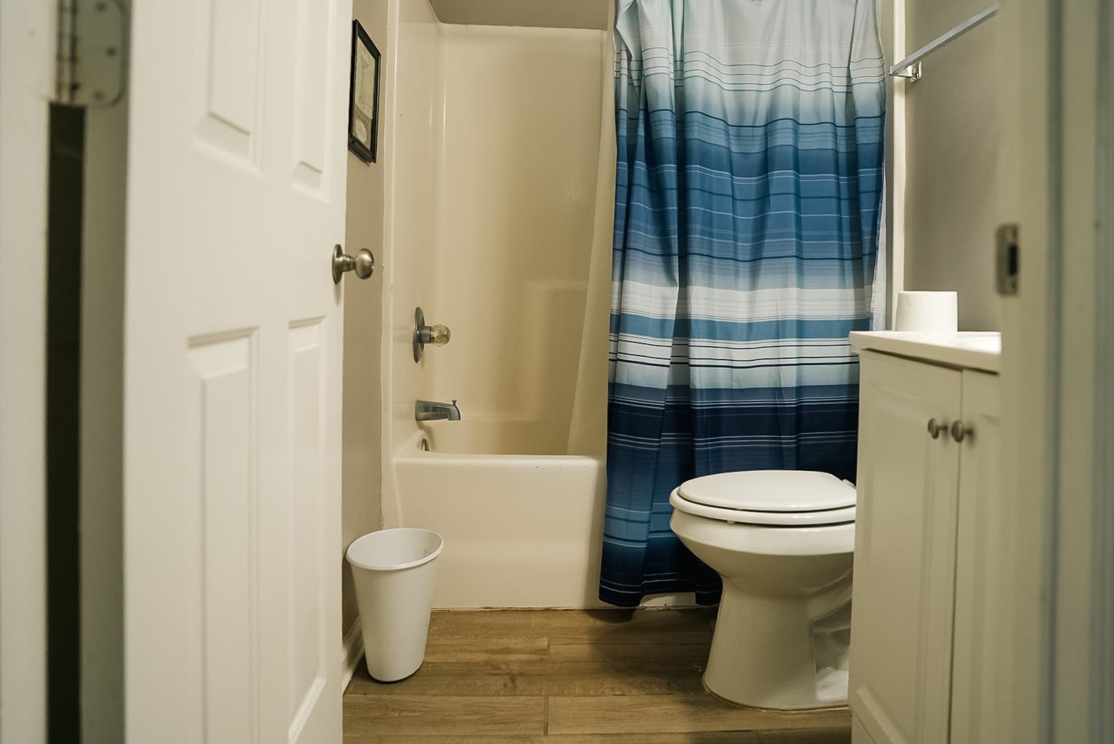 936 Porter Street Memphis, TN 38126 - Photo 21 of 22 Full bath featuring wood finished floors, vanity, and shower / bathtub combination with curtain