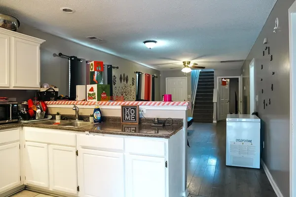 a kitchen with sink refrigerator and cabinets