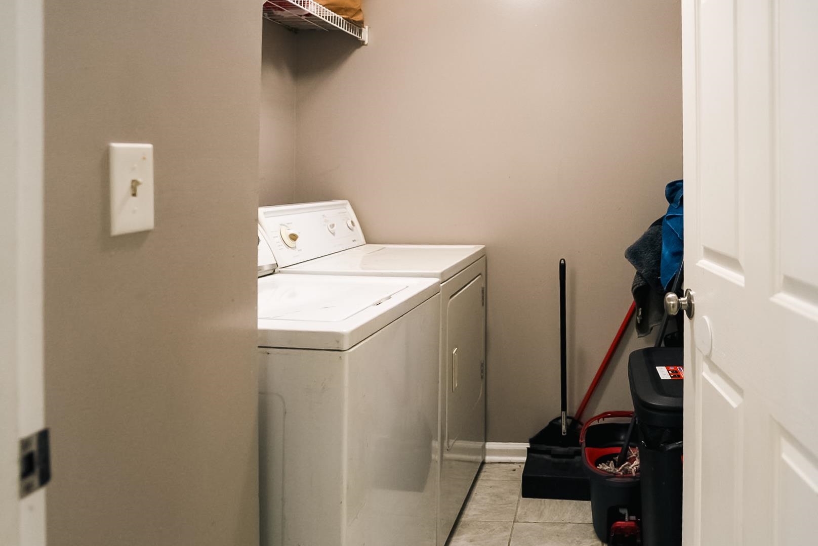 936 Porter Street Memphis, TN 38126 - Photo 7 of 22 Laundry area with washer and clothes dryer and light tile patterned flooring