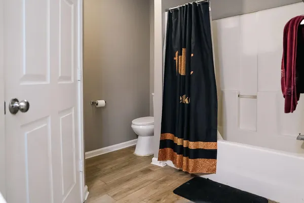 a bathroom with a toilet and a shower
