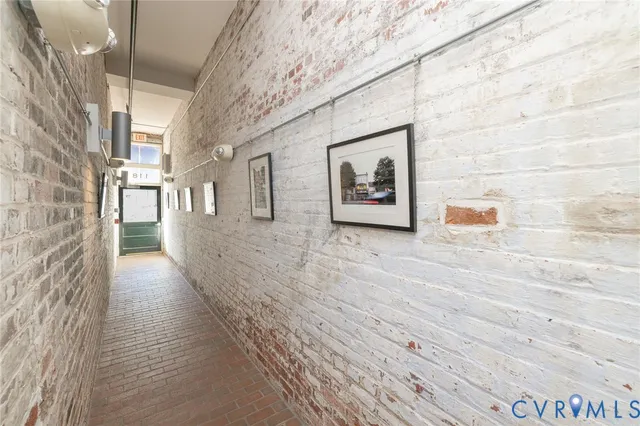 a view of a hallway with wooden floor and a large window