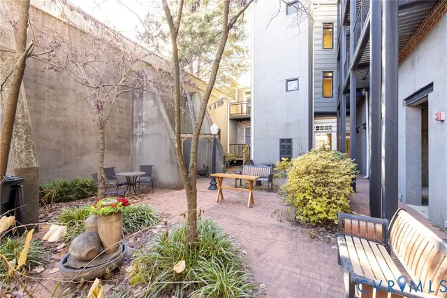 a view of a patio with table and chairs and potted plants